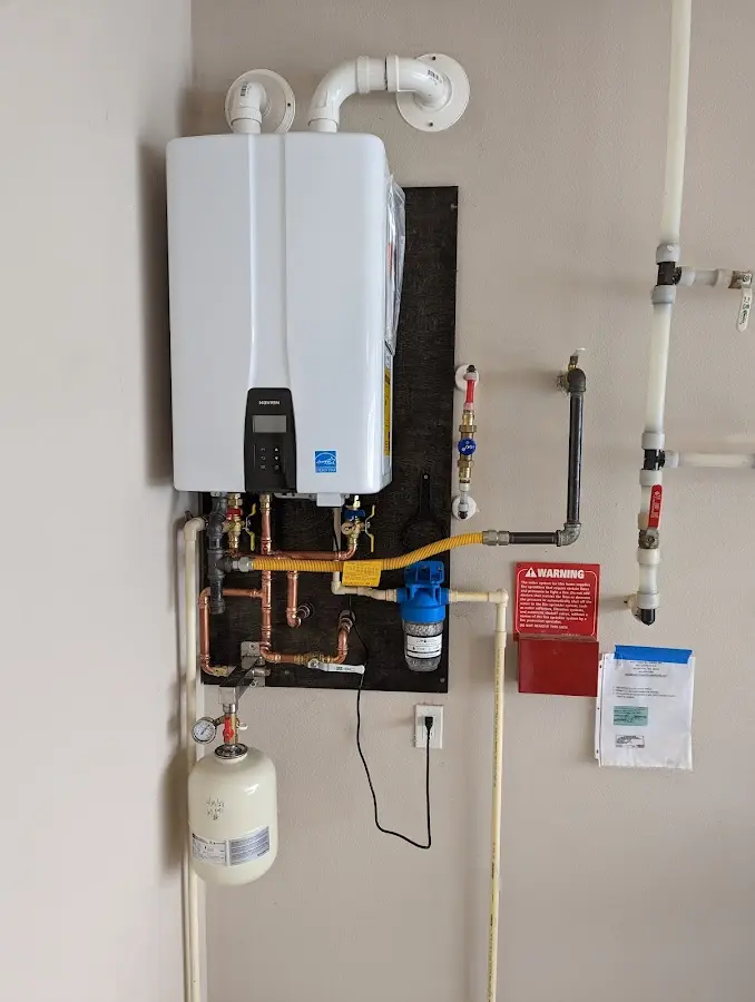 Professional plumber installing copper piping in a Kinderhook home